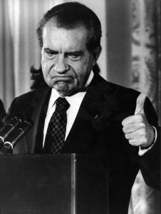 Richard Nixon gives a thumbs up